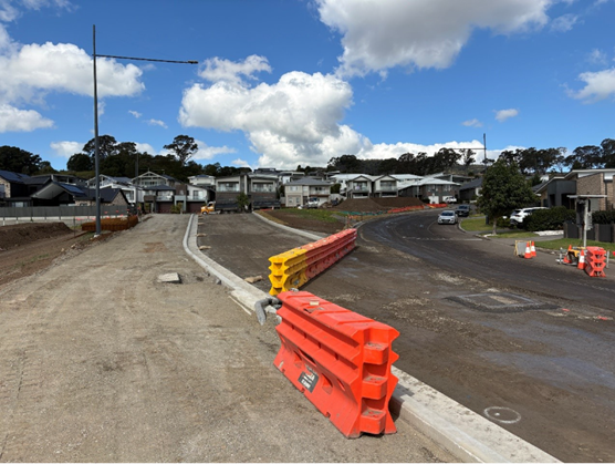 Construction crews undertaking road upgrade works on Yellow Rock Road in Tullimbar, including pavement, kerb and utility improvements.